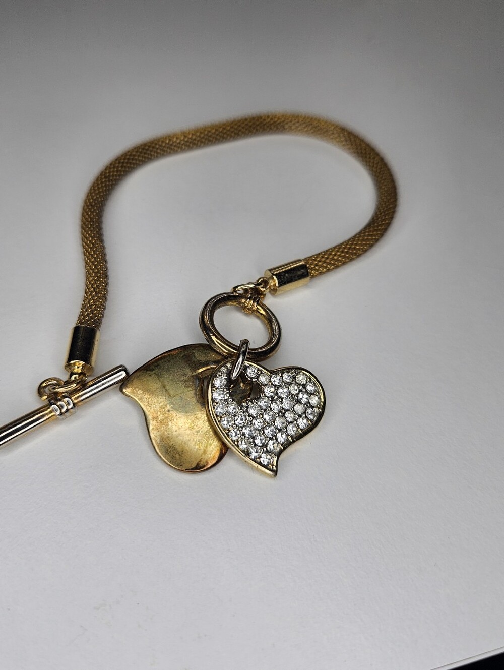 Captivating Charm: Gold Tone Bracelet with Heart Dangle Charms and Rhinestones